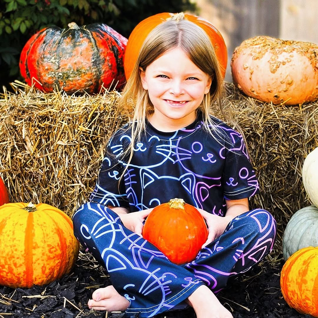 A Curious Fox student smiling with a pumpkin